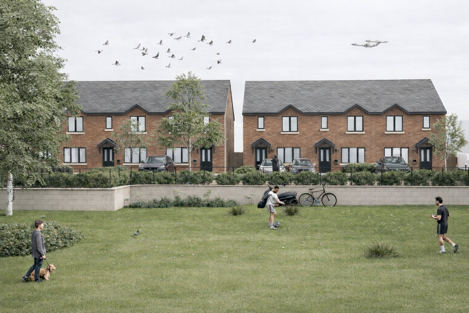 New residential housing development with brick townhouses overlooking shared green space and pedestrian routes.